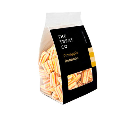 Pineapple Bonbons in a clear bag from The Treat Co, showcasing bold orange and yellow stripes.