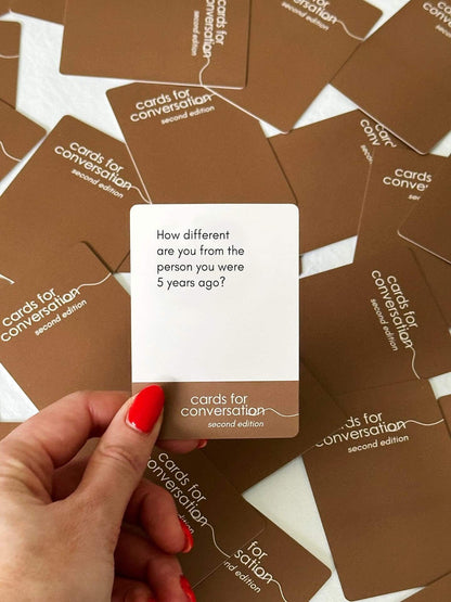 Hand holding a prompt card from Cards for Conversation: Second Edition with a question about personal growth.