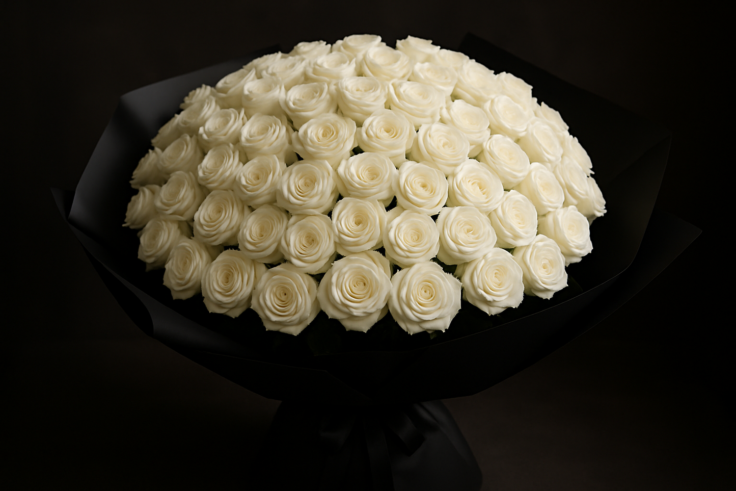 A bouquet of 75 white roses in black paper